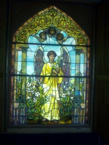 After a fire destroyed the historic First Unitarian Church's sanctuary, the members were able to save some of the original stained glass, keeping and memorializing these precious windows in the new church buildings. This majestic, wall height window, is but one of them.
